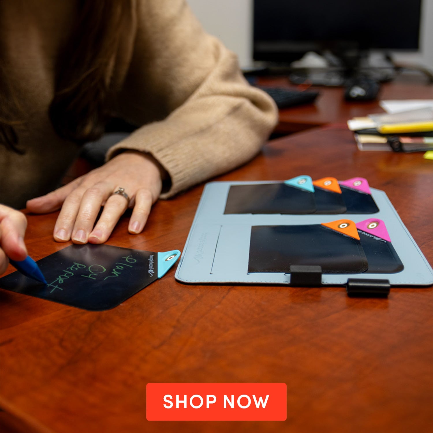 Woman at desk writing on a VersaNote