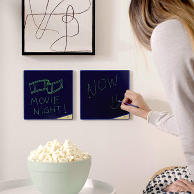 woman writing a note on a wall mounted VersaTile