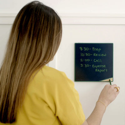 Woman erasing VersaTile by tapping stylus in bottom corner