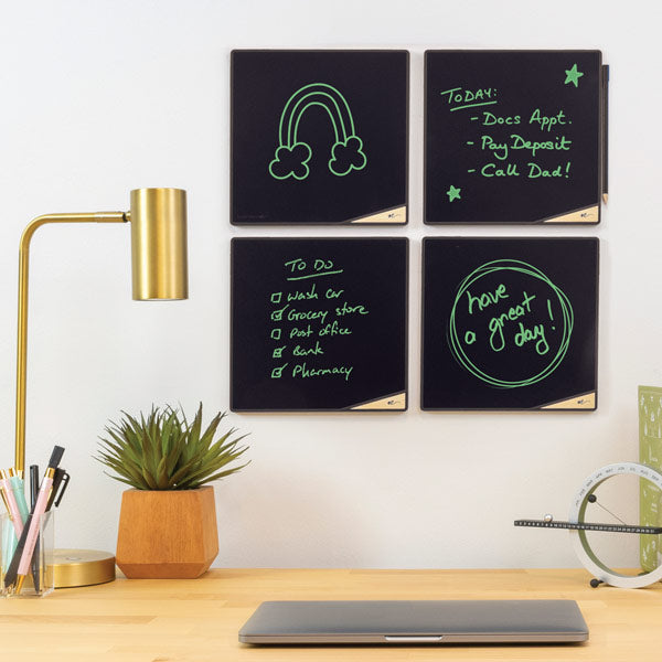 Four VersaTiles mounted on wall above desk in an office