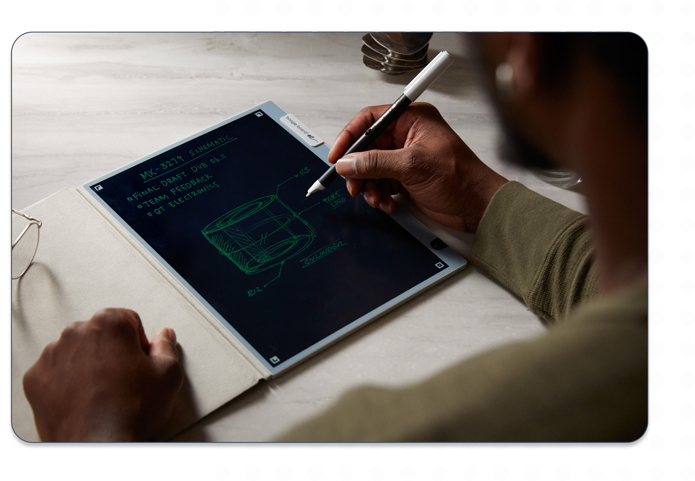 Over the shoulder view of a man using Blackboard Smart Pen to write on a Blackboard 2.0